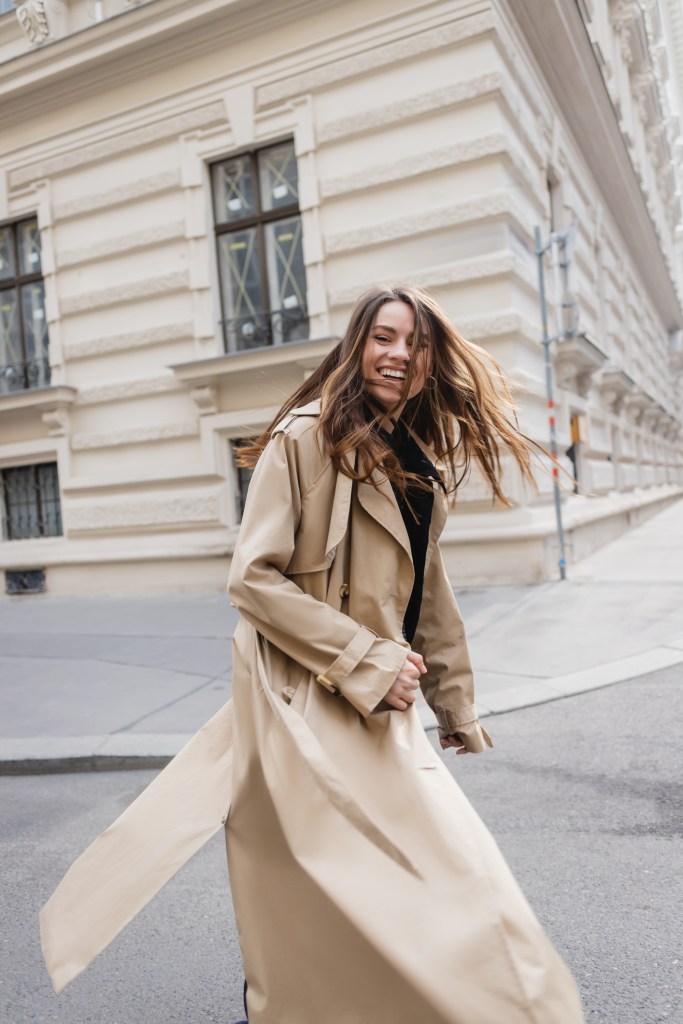 woman wearing trench coat in the city