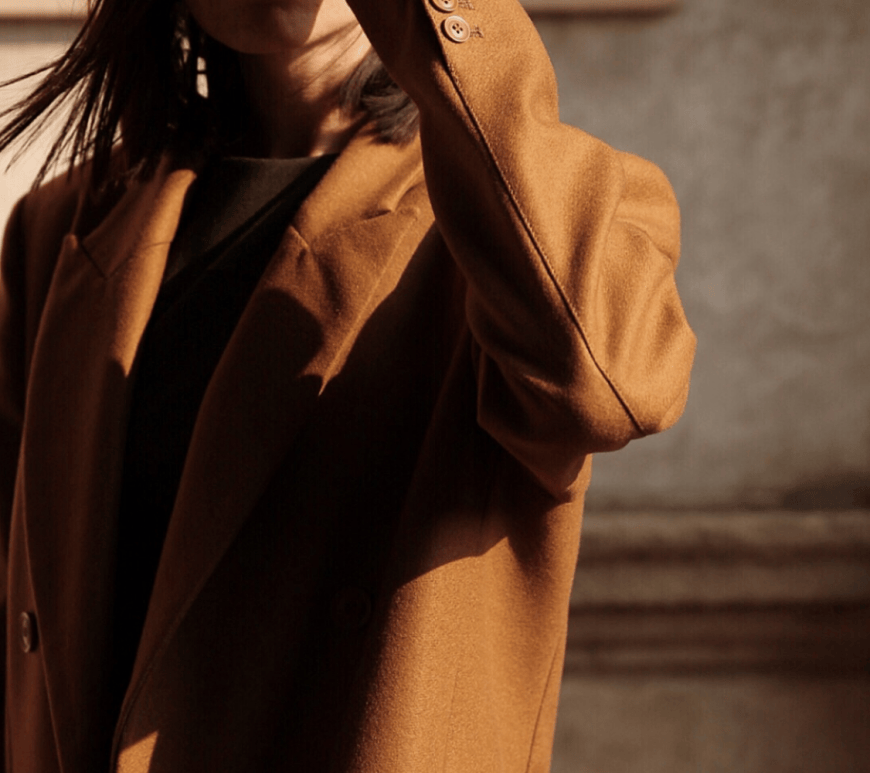 A woman wearing a camel coat