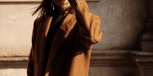 A woman wearing a camel coat